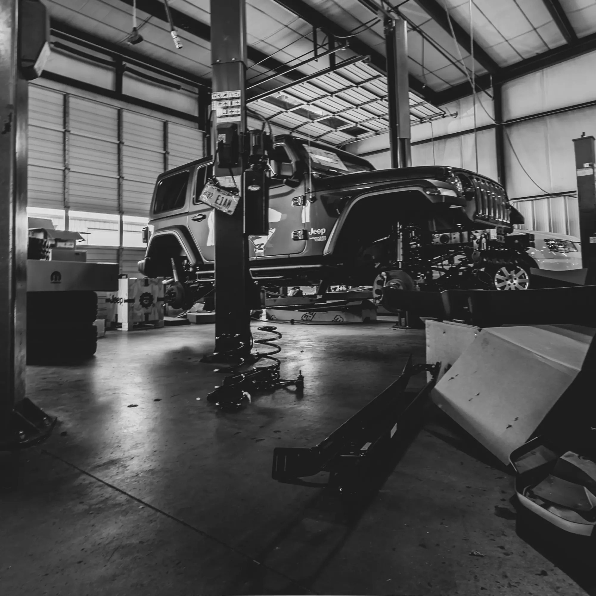 A Jeep up on the lift in Floorjack Auto's Phoenix service bay